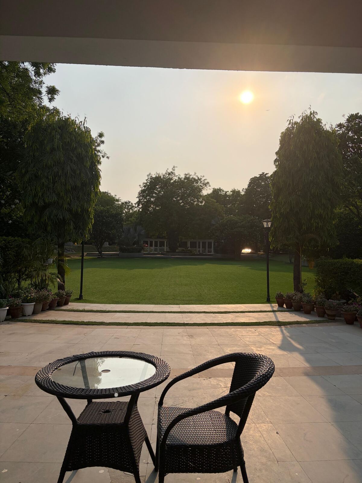 Evening sun over the main lawn, seen from the verandah at House of Joy